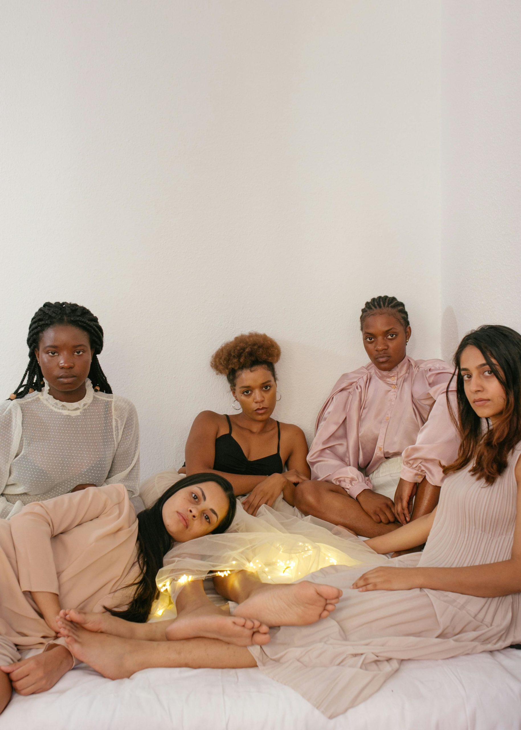 5 femmes réunies dans un décor rose pâle